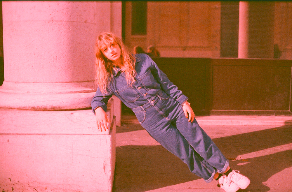 “Expired film photo of a woman wearing overalls in Paris, captured with a Canon F1.”