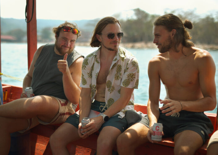 Travelers enjoying a boat party around Koh Rong Sanloem, Cambodia, with snorkeling, music, and drinks